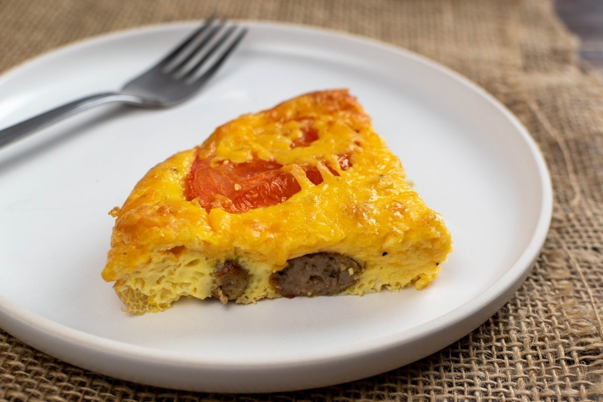 a piece of sausage and pepper quiche.