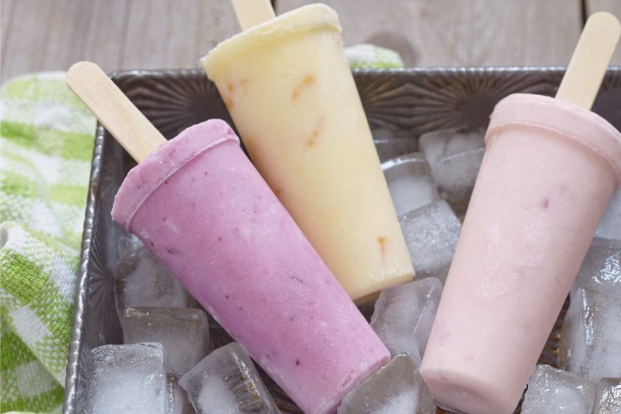Three flavors of fruit yogurt popsicles.
