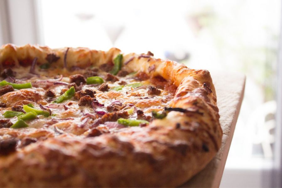 Sloppy Joe style pizza, soft focus background.