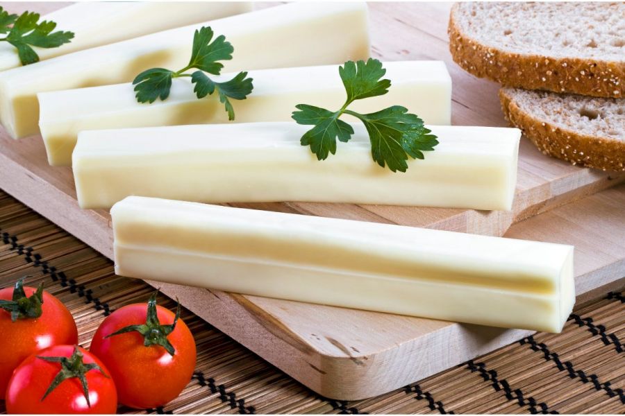 Cheddar cheese sticks, bread and baby tomatoes.