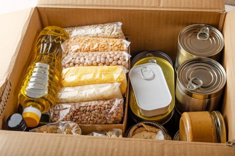 Cardboard box with home food supplies for the pantry.